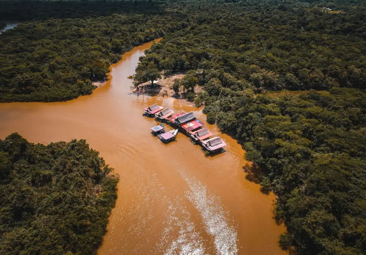 Aerial view of Amazon rainforest with deforested patches and cleared land visible through mist