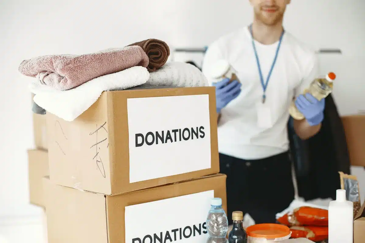 Diverse donated art materials including paints, fabric, and construction items organized at a reuse center