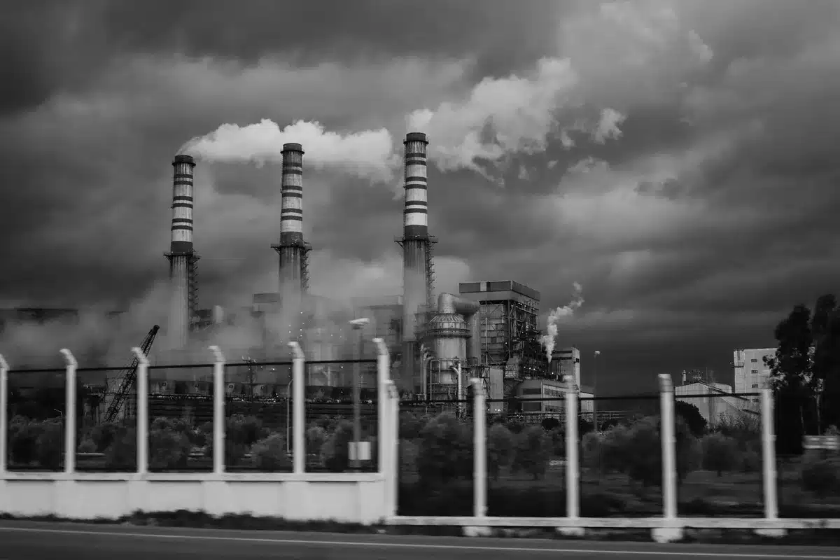 Industrial facility with emissions illustrating the balance between economic development and environmental protection