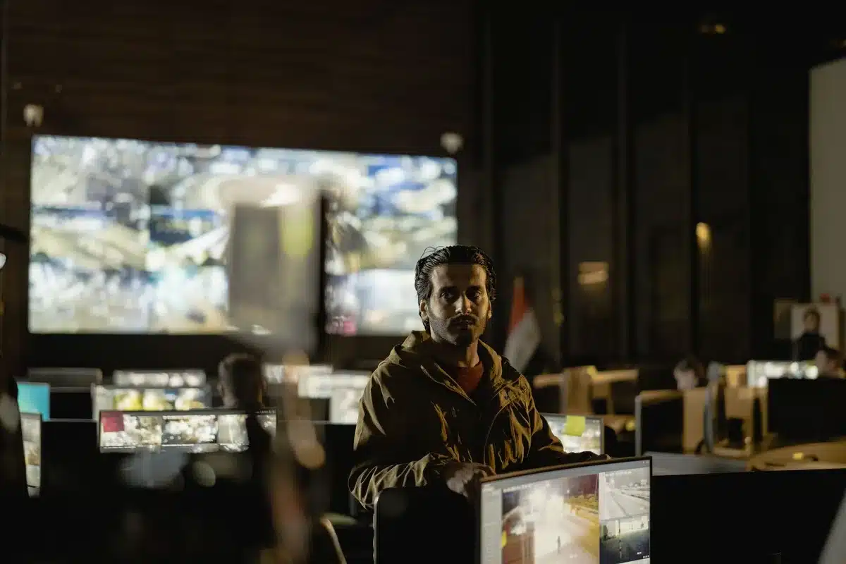 Soldiers reviewing drone tactical data in a military command center with multiple monitors