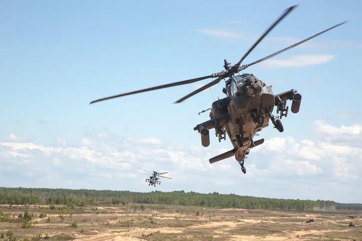 F-35 jet and Apache helicopter side by side representing paired operations