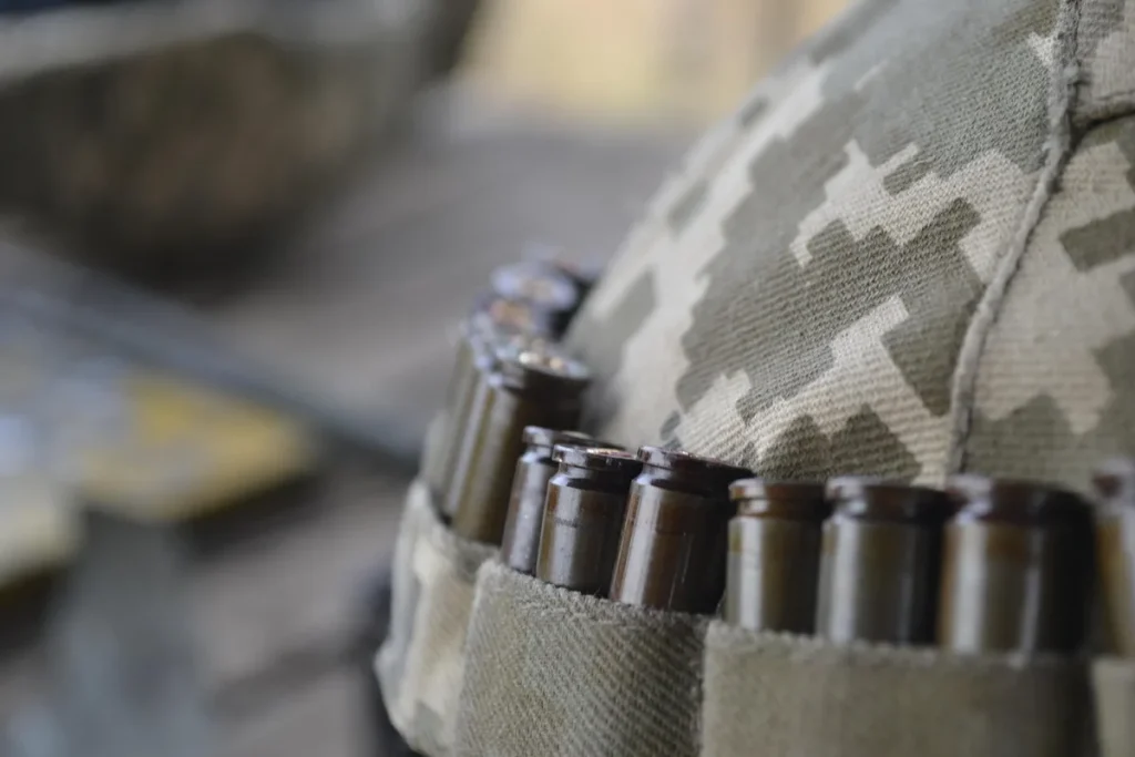 Inflatable military decoys on a training field with anonymous personnel adjusting equipment