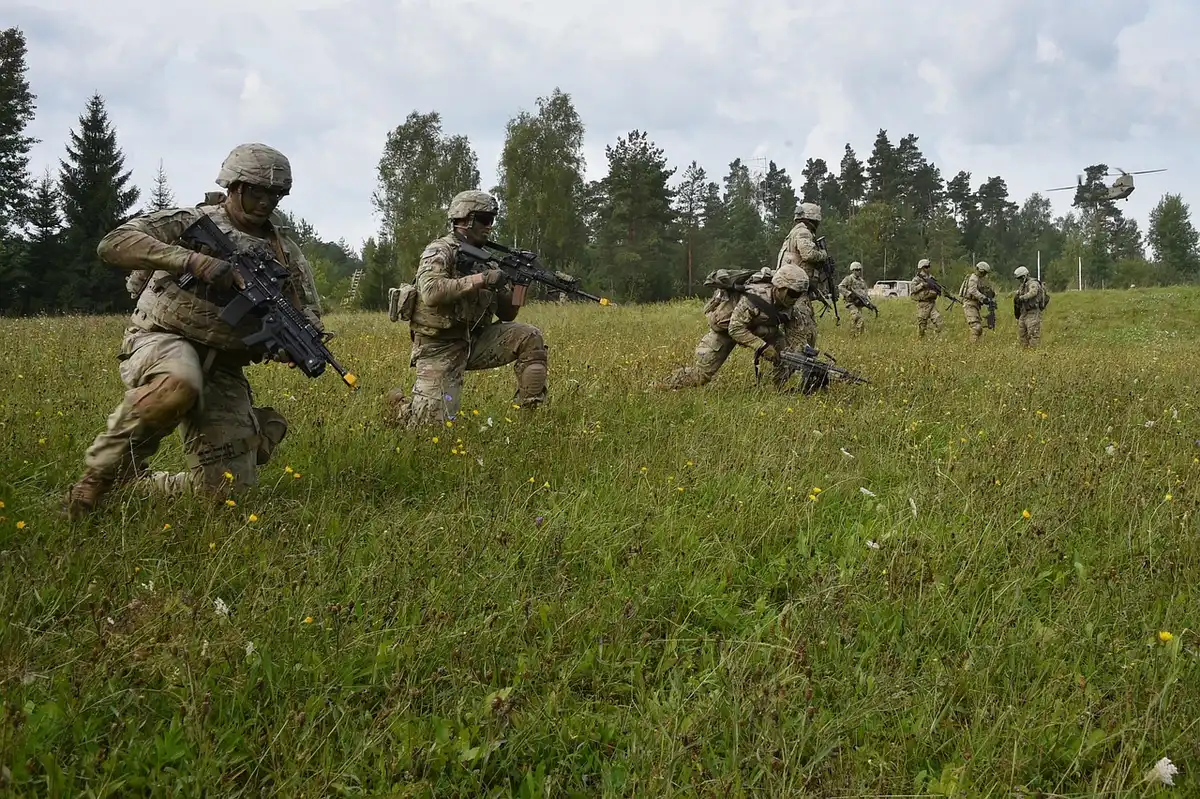 Military personnel working with advanced equipment and technology in a field deployment setting.
